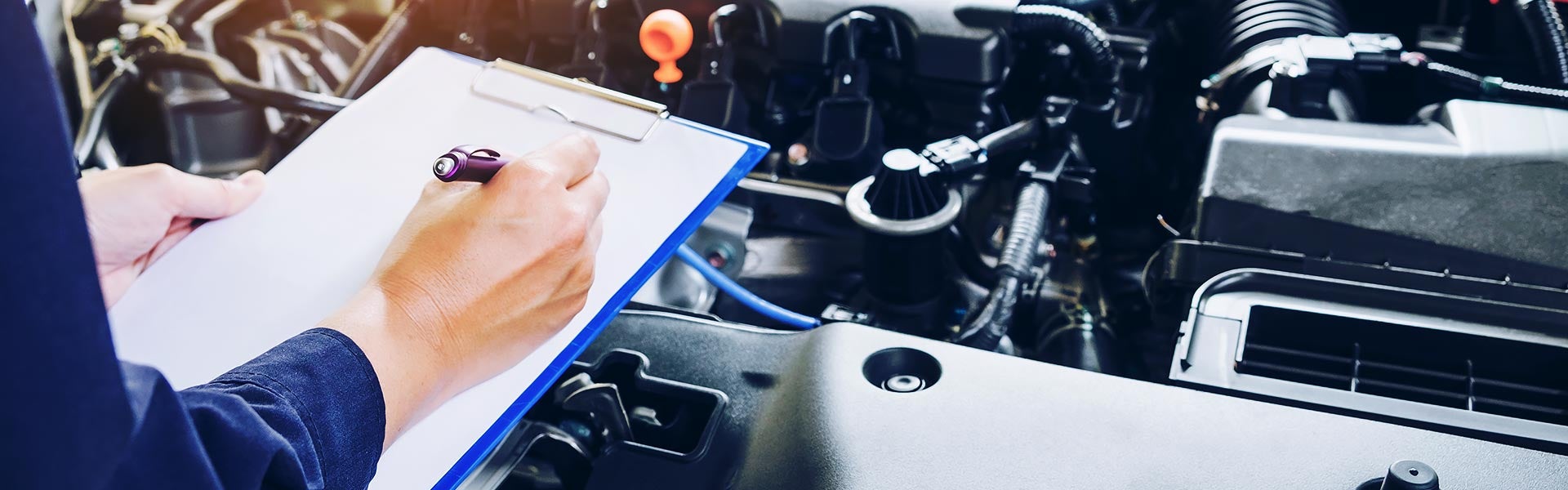 Mechanic holding a clipboard